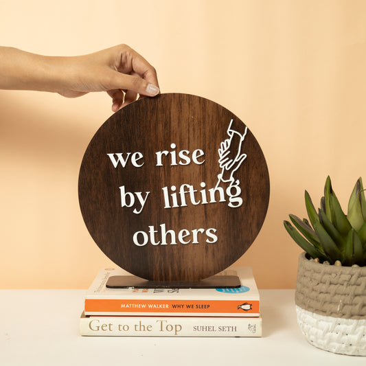 Inspirational Round Wooden Wall Sign – We Rise by Lifting Others